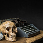 still life with human skull, old typewriter and alarm clock ]on wooden table